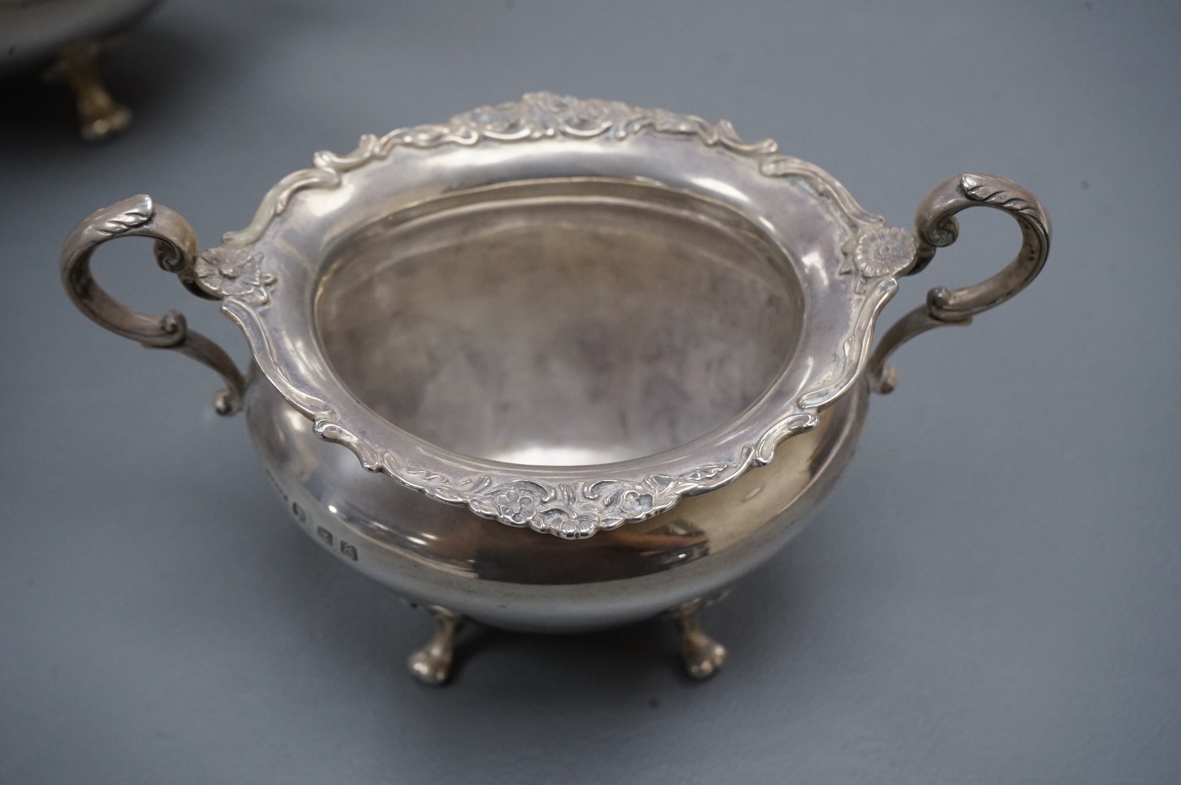 An Edwardian Scottish silver three piece oval tea set by Weir & Sons, Glasgow, 1901, gross 25.5oz, with foliate borders.